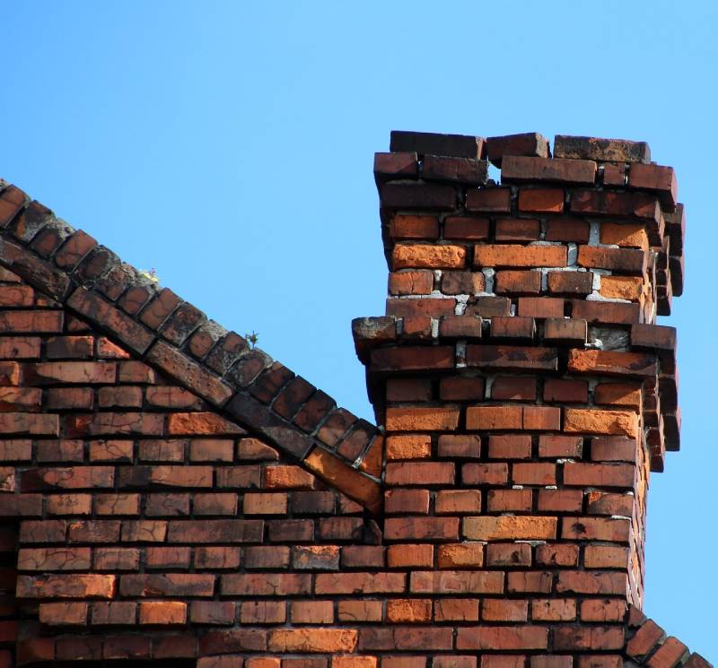 Damaged chimney on an Gaithersburg home showing cracks and missing mortar